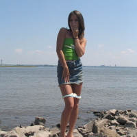 Gorgeous young brunette Melissa Doll teasing outdoors