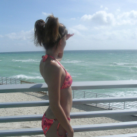 Melissa peels back her bikini and shows a pink plump pussy