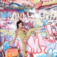 Brunette model Roxy Raye posing solo in ripped mesh bodystocking