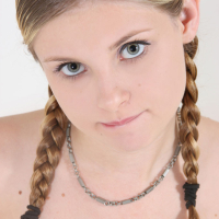 Lil Candy sports a set of braided pigtails while she spreads her tight pussy