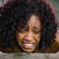 Lotus Lain ebony is bound to a wooden box with a blonde in there
