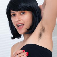 Andy Moon is showing off her black top and blue skirt She has beautiful hairy pits and a lovely smile She strips off her white stockings and has a hot hairy pussy She is hairy and totally all natural