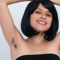 Andy Moon is showing off her black top and blue skirt She has beautiful hairy pits and a lovely smile She strips off her white stockings and has a hot hairy pussy She is hairy and totally all natural