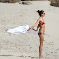 Olivia Palermo pulling down her skimpy bikini top at the beach in St Barts