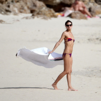 Olivia Palermo pulling down her skimpy bikini top at the beach in St Barts
