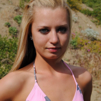 Perky blonde teen Codie Sweets shows off her tight round ass outdoors as she strips out of her string bikini