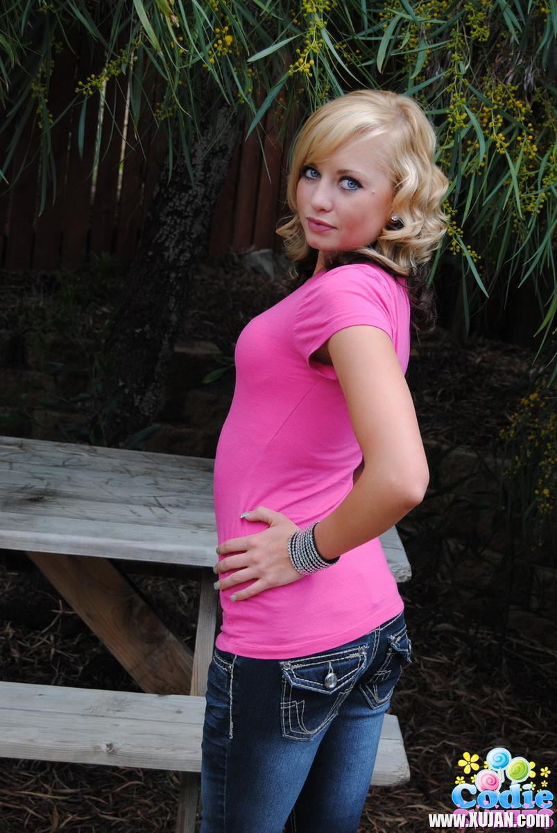 Teasing blonde Codie Sweets pulls down her tight jeans showing off her perfect teenage ass outdoors - Photo #2345189