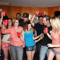 Slutty girls having fun at the drunk party with lascivious guys