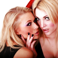 Seductive blonde vixens posing in latex dresses and high heeled shoes