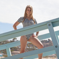 Sexy coed Veronica Weston teases outside on a beach