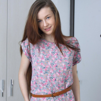 Solo chick Emily Bloom gets naked and shows her shaved pussy