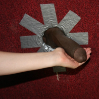 Redhead teenie sucks two huge black cocks through a gloryhole