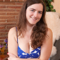In her armchair Snow is posing in her blue dress and white panties She strokes her hairy pits and then her hairy pussy She finds a special spot spreads her legs touches her body and has fun