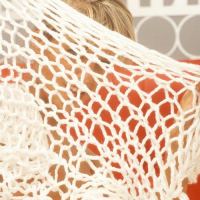 Young blonde angel in snow white garments strips