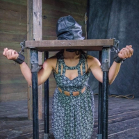 Mia Gold is bound in metal with leather mask and clamps