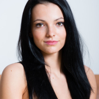 Dark haired girl Sapphira A shedding see thru black lingerie in nylons