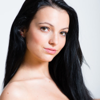 Dark haired girl Sapphira A shedding see thru black lingerie in nylons