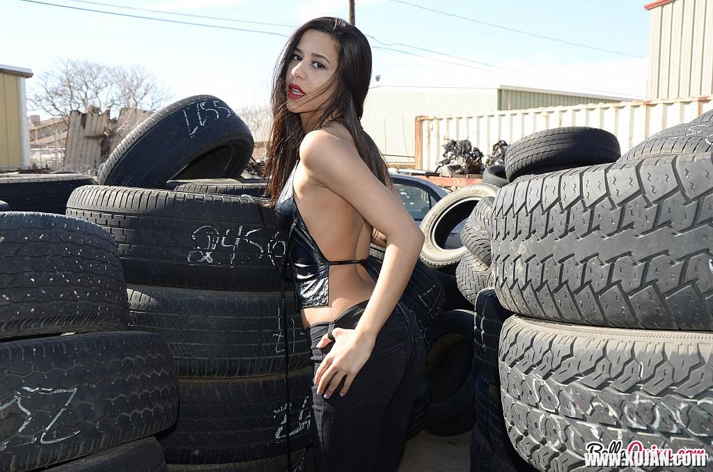 Brunette coed Bella Quinn teases at a tire yard - Photo #2553249
