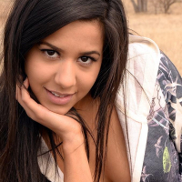 Brunette teen Bella Quinn teases on the bench outside