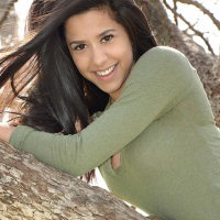 Brunette teen Bella Quinn teases and poses in the tree