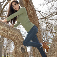 Brunette teen Bella Quinn teases and poses in the tree