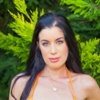 Gorgeous April Blue posing in an orange bikini outdoors