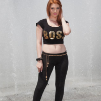 Redhead babe Lilith Lust flashes her crotch tatoo outside