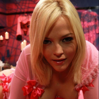 Glamorous blonde Alexis Texas bends over to show her ass in red lingerie