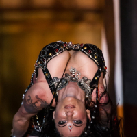 Jenevieve Hexxx poses with snakes as a dancer and at the ED awards