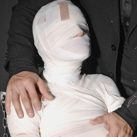 Leyla Black is mummified and spanked pussy exposed