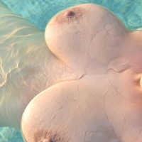 Big breasted bikini babe gets wet