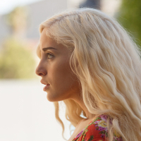 Blonde beauty Naomi Woods poses in sexy dress