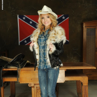 Milf babe Nataly Von posing in cowgirl uniform and cowgirl hat
