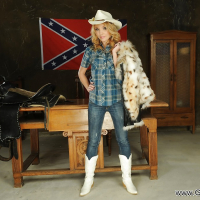 Milf babe Nataly Von posing in cowgirl uniform and cowgirl hat