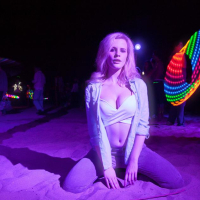 Blonde coed Catie Parker has some fun on a beach at night