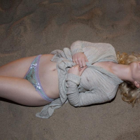 Blonde coed Catie Parker has some fun on a beach at night