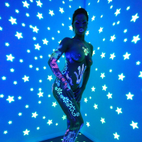 Angel Dark has her sexy booty and tits prettified with glowing bodyart