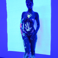 Angel Dark has her sexy booty and tits prettified with glowing bodyart