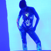 Angel Dark has her sexy booty and tits prettified with glowing bodyart