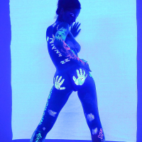 Angel Dark has her sexy booty and tits prettified with glowing bodyart