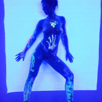 Angel Dark has her sexy booty and tits prettified with glowing bodyart