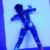Angel Dark has her sexy booty and tits prettified with glowing bodyart