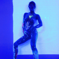 Angel Dark has her sexy booty and tits prettified with glowing bodyart
