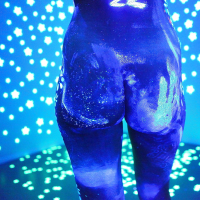 Angel Dark has her sexy booty and tits prettified with glowing bodyart