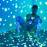 Angel Dark has her sexy booty and tits prettified with glowing bodyart