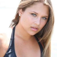Lili Jensen has some fun in the ocean in a tiny bikini