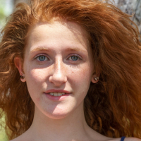 Redhead beauty Foxy Lee stripping outdoors