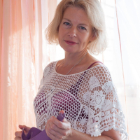 Diana Douglas is watering her plants when the feeling of masturbating hits her She strips naked on her sofa and enjoys her naked hairy body She touches her pussy all over and has hot times