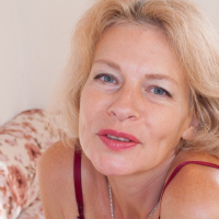 Diana Douglas is watering her plants when the feeling of masturbating hits her She strips naked on her sofa and enjoys her naked hairy body She touches her pussy all over and has hot times