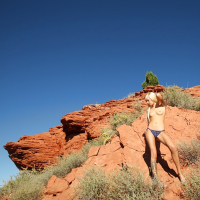 Graceful blonde Emma Mae stripping off her top and panties outdoor